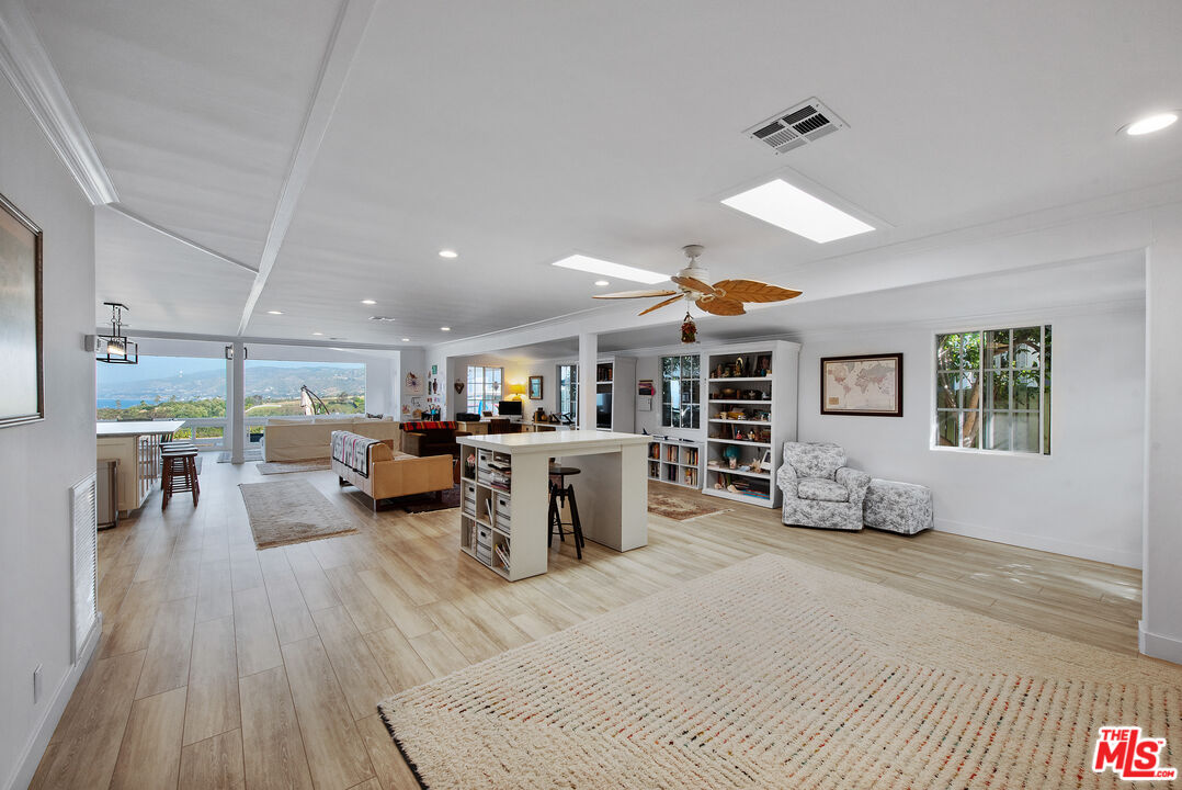 29500 Heathercliff Road, Unit 202 Malibu, CA 90265 - Photo 9 of 36 a living room with furniture and a wooden floor