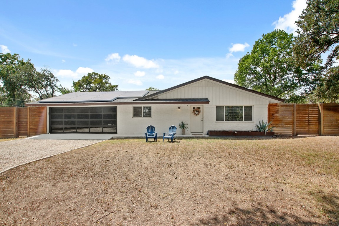 9110 Chisholm Lane Austin, TX 78748 - Photo 1 of 27 a view of a house with a yard and garage