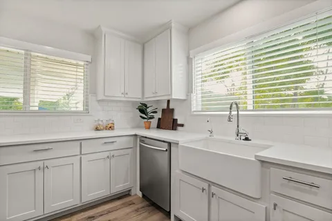 a kitchen with a sink cabinets and window