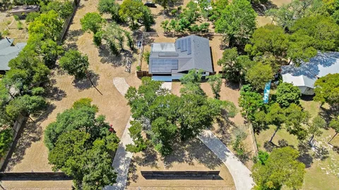 an aerial view of a house with a yard and garden