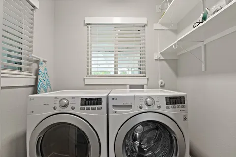 a view of washer and dryer with kitchen in the background