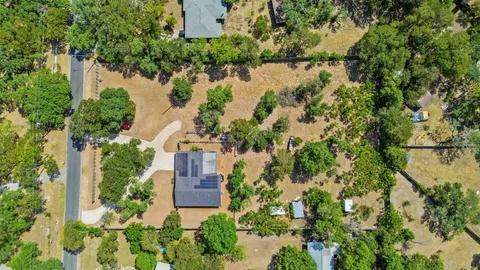 an aerial view of house with yard and lake view