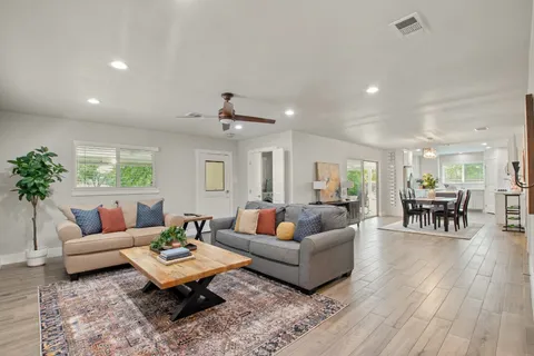 a living room with furniture and wooden floor