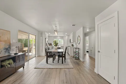a view of a dining room with furniture and wooden floor