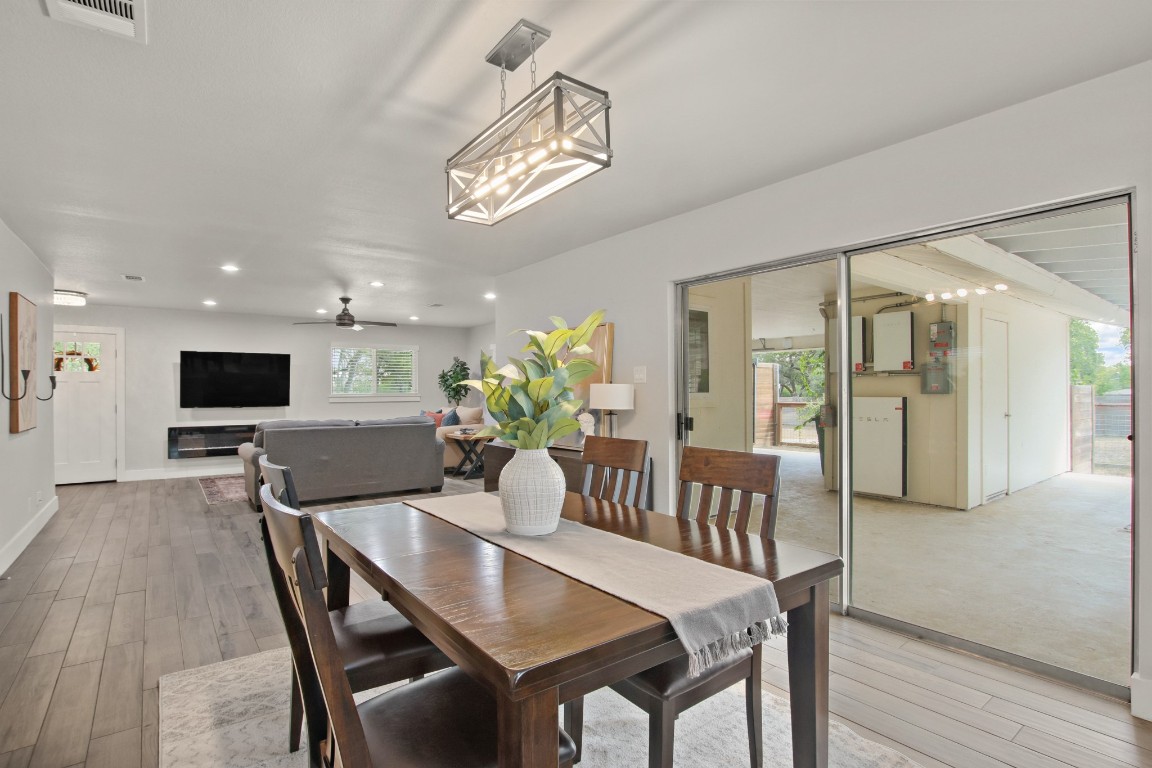 9110 Chisholm Lane Austin, TX 78748 - Photo 7 of 27 a view of a dining room with furniture and wooden floor