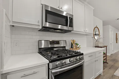 a kitchen with a stove and a microwave