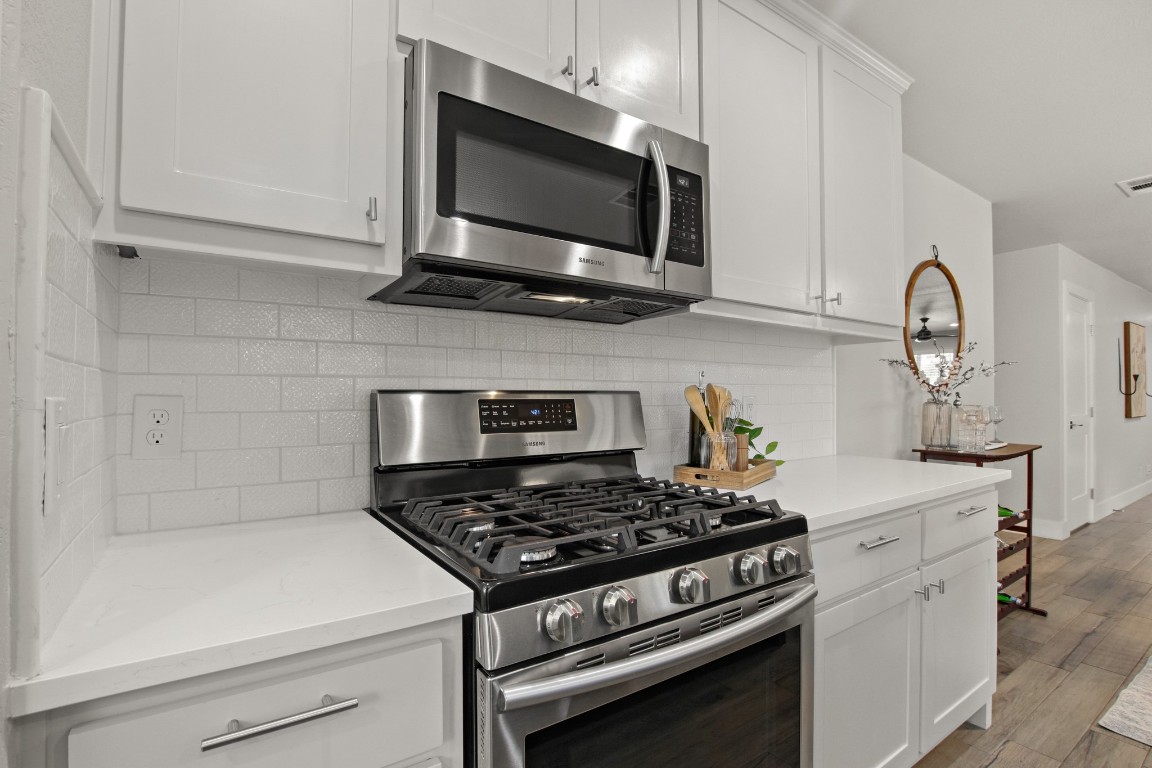9110 Chisholm Lane Austin, TX 78748 - Photo 10 of 27 a kitchen with a stove and a microwave