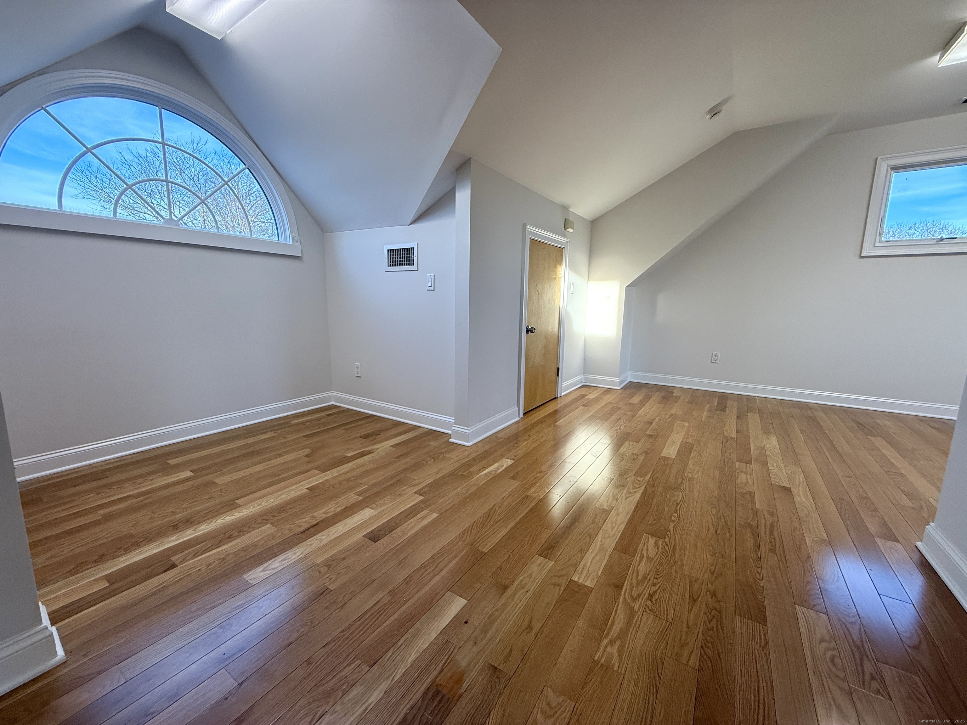 5 Myrtle Street Norwalk, CT 06855 - Photo 12 of 15 an empty room with wooden floor and windows
