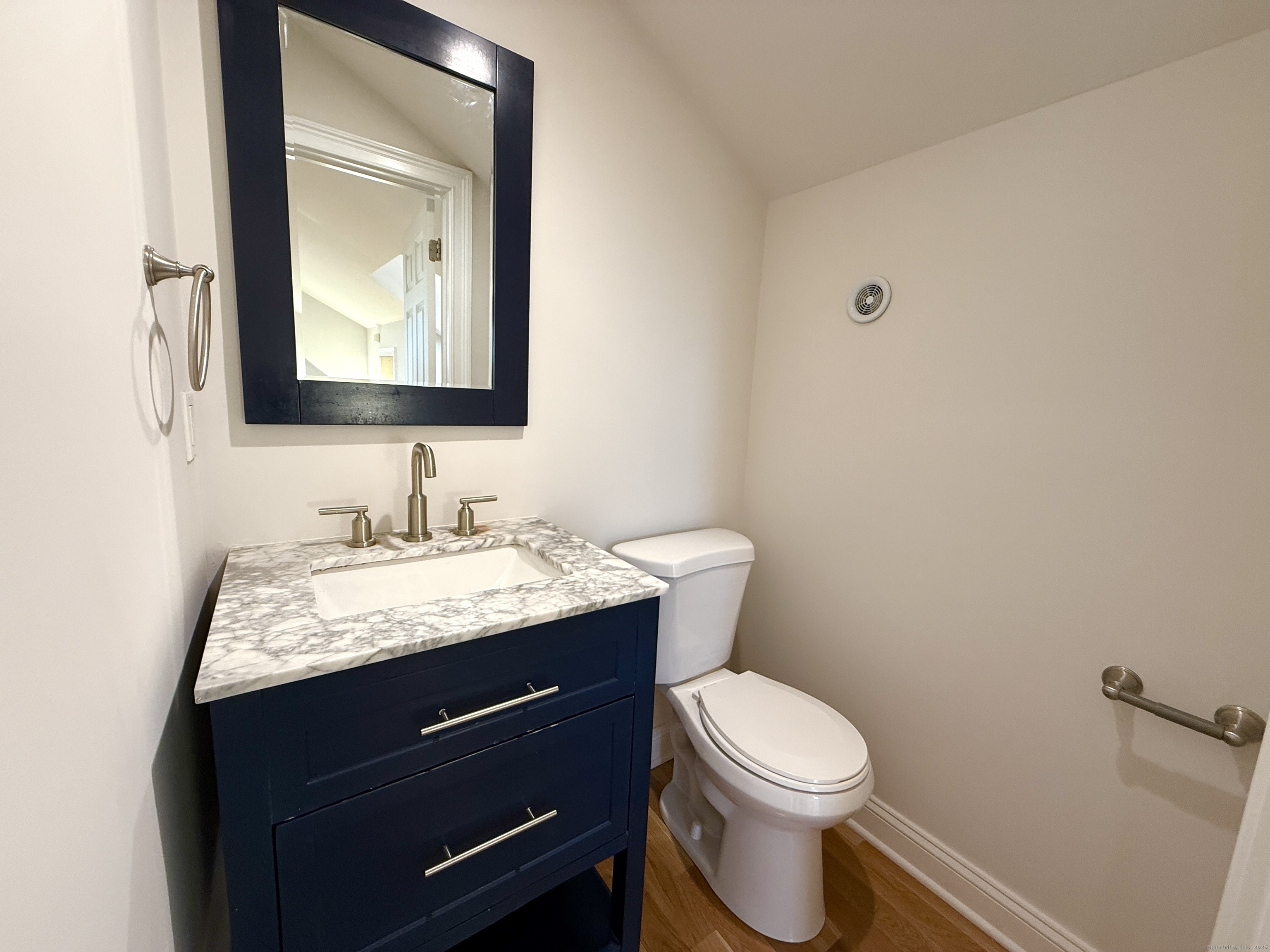 5 Myrtle Street Norwalk, CT 06855 - Photo 13 of 15 a bathroom with a granite countertop toilet sink and mirror
