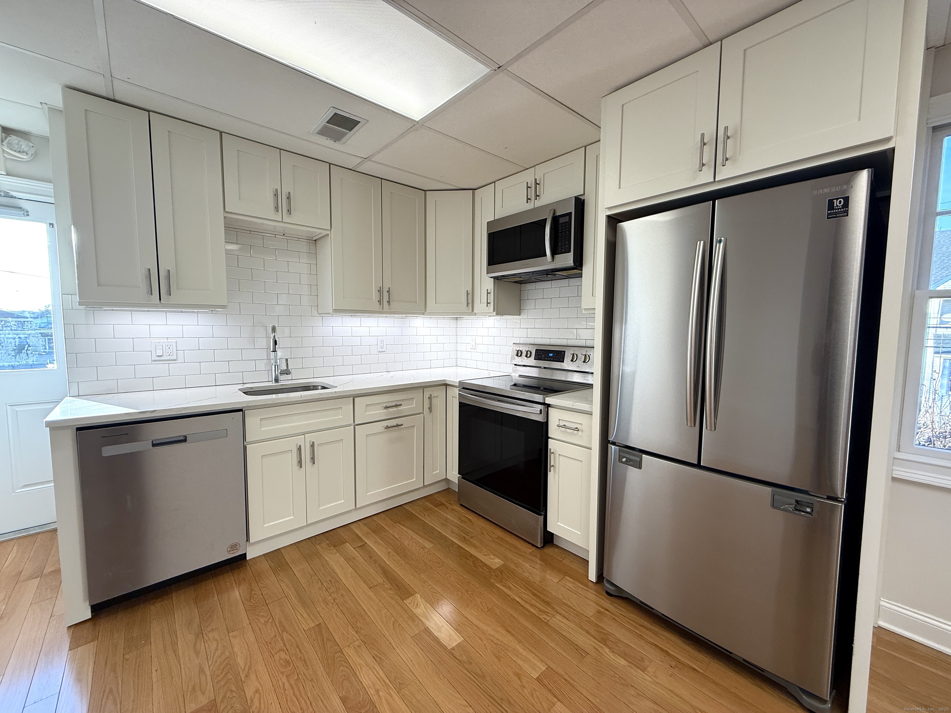 5 Myrtle Street Norwalk, CT 06855 - Photo 2 of 15 a kitchen with a refrigerator cabinets and wooden floor