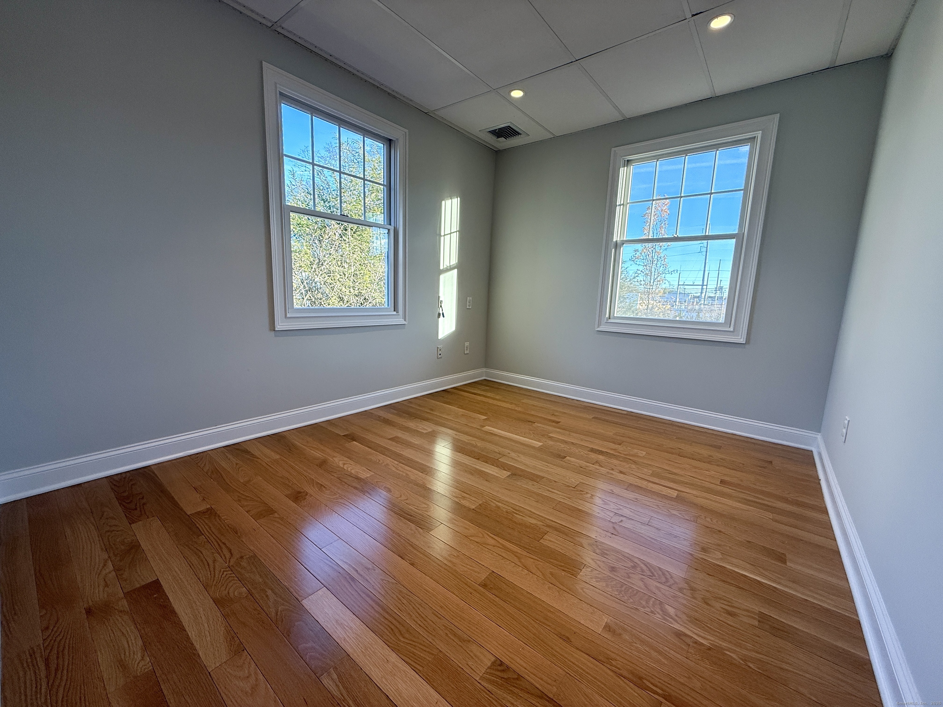 5 Myrtle Street Norwalk, CT 06855 - Photo 10 of 15 an empty room with wooden floor and windows