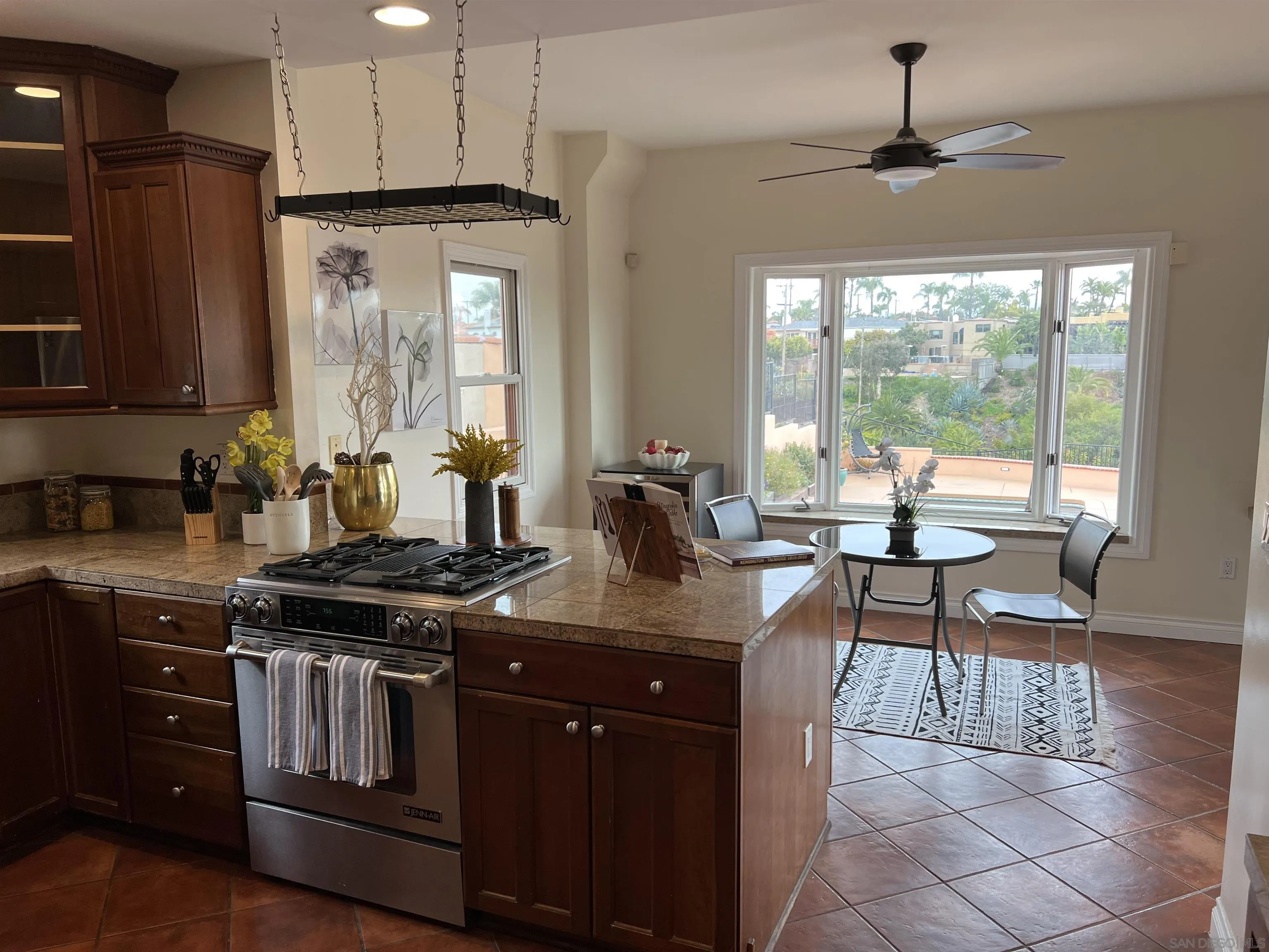 4196 Rochester Road San Diego, CA 92116 - Photo 16 of 72 a kitchen with stainless steel appliances granite countertop a stove a sink and a refrigerator