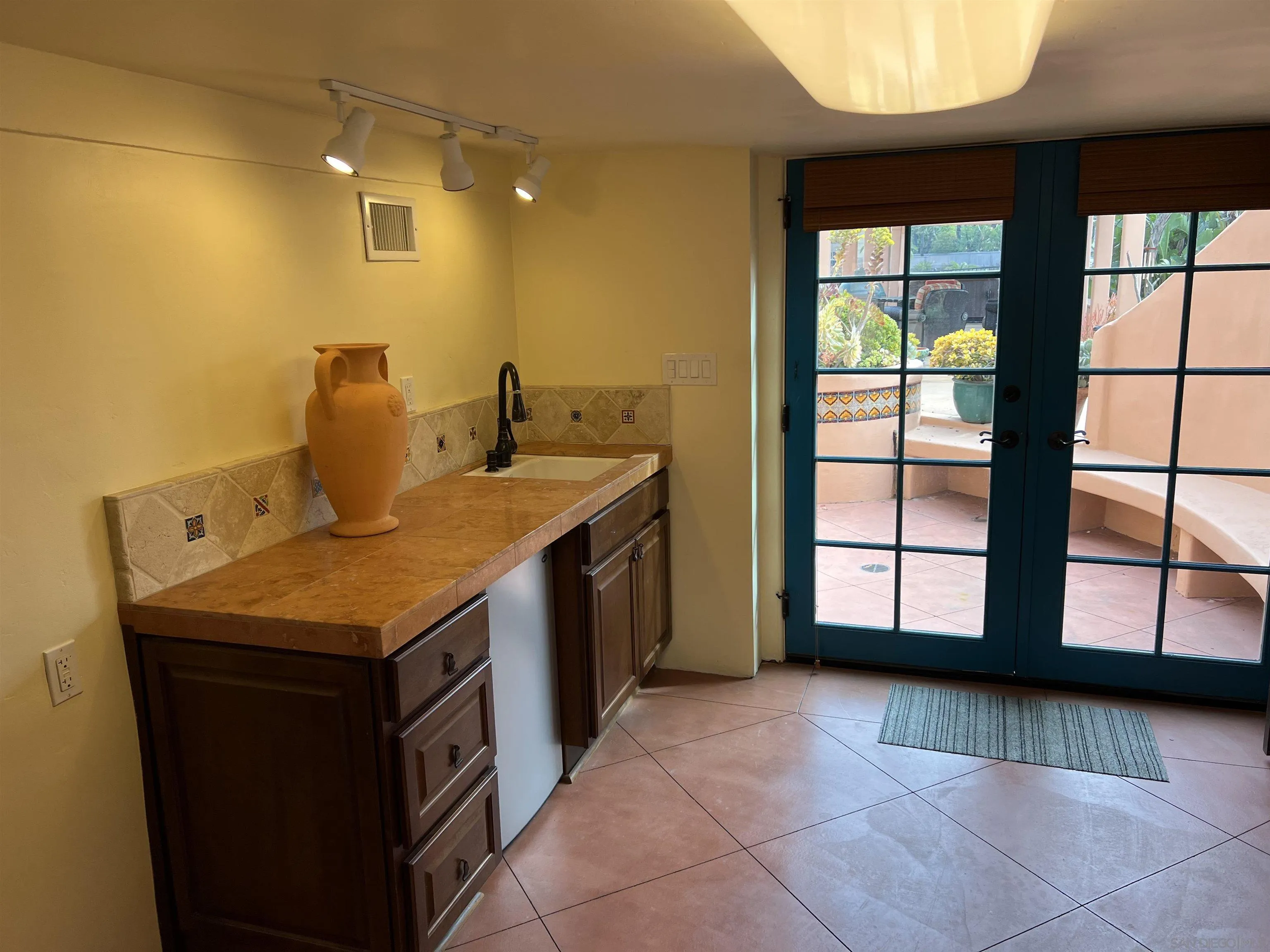 4196 Rochester Road San Diego, CA 92116 - Photo 50 of 72 a kitchen with a sink a counter top space and cabinets