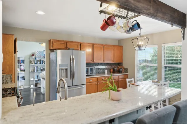 a kitchen with a refrigerator a stove and a sink