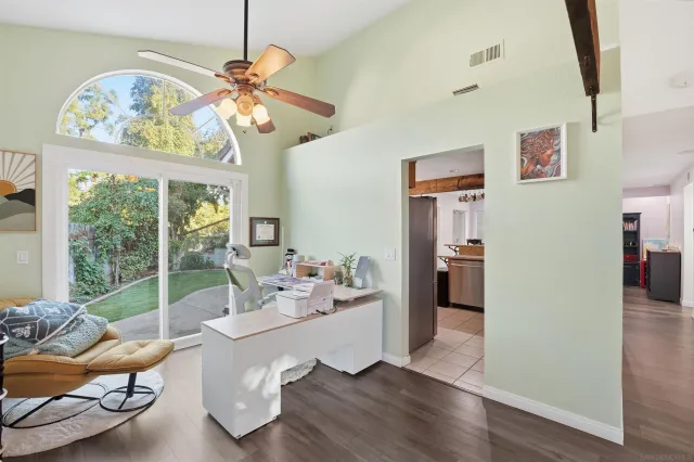 a dining room with wooden floor a chandelier a wooden table and chairs