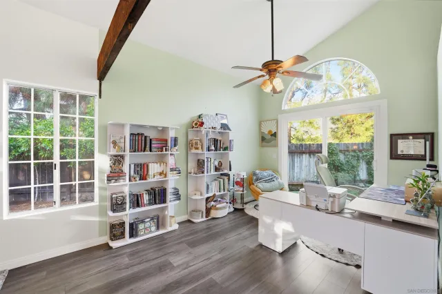 a room with wooden floor and large window