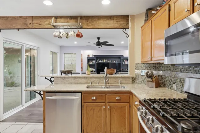 a kitchen with a counter space a stove and cabinets