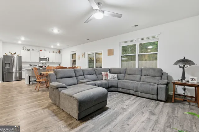 a view of a dining room with furniture window and wooden floor