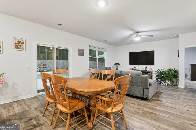 a kitchen with granite countertop a refrigerator and microwave