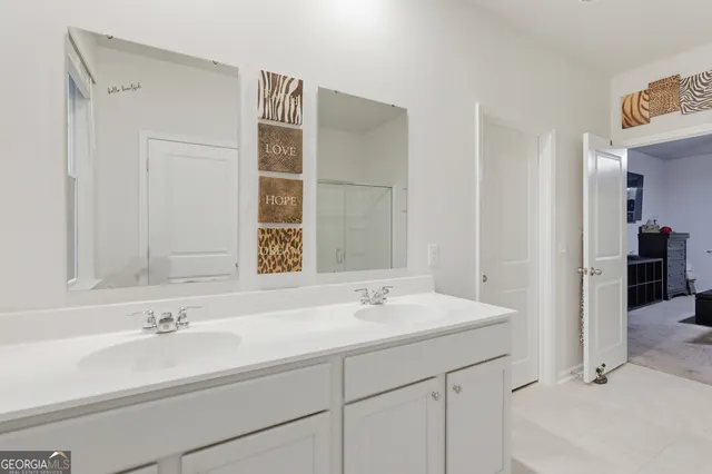 a spacious bedroom with a bed and a ceiling fan