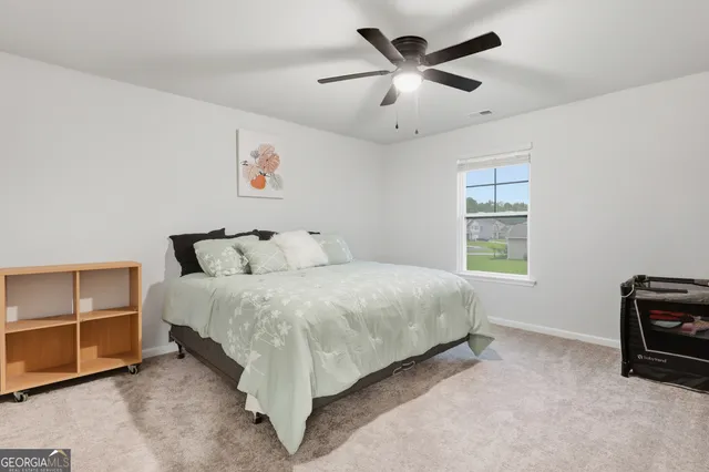 a bedroom with a bed and window