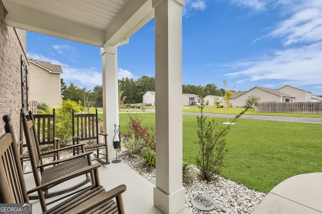 a view of a backyard with swimming pool and furniture