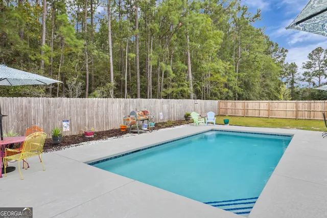a view of a patio with swimming pool table and chairs