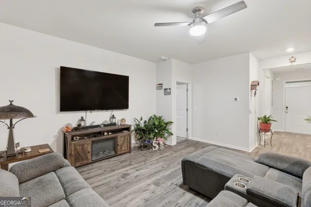 a living room with furniture and a flat screen tv