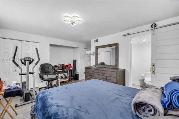 a bedroom with bed and cabinets