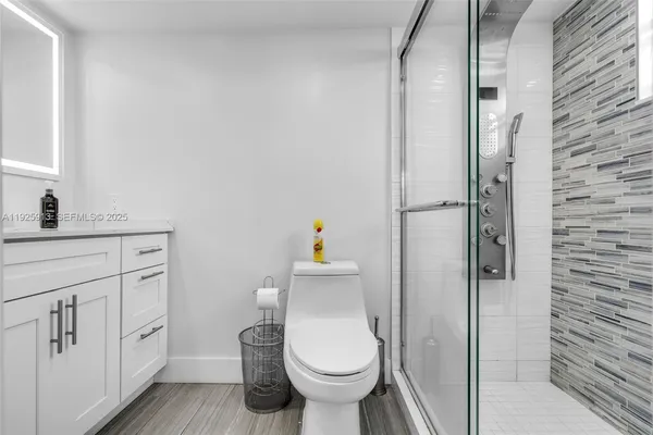 a bathroom with a toilet sink and shower