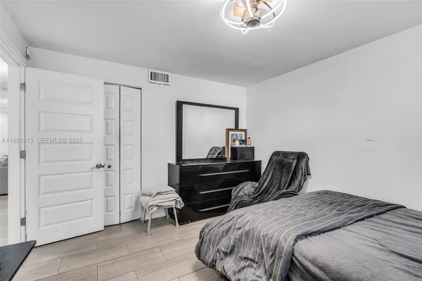 a bedroom with a bed and a mirror
