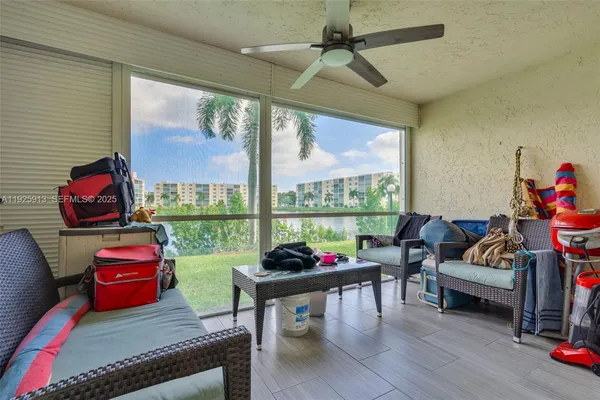 a living room with furniture and a floor to ceiling window