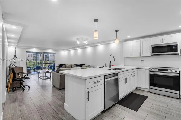 a kitchen with sink stove and cabinets