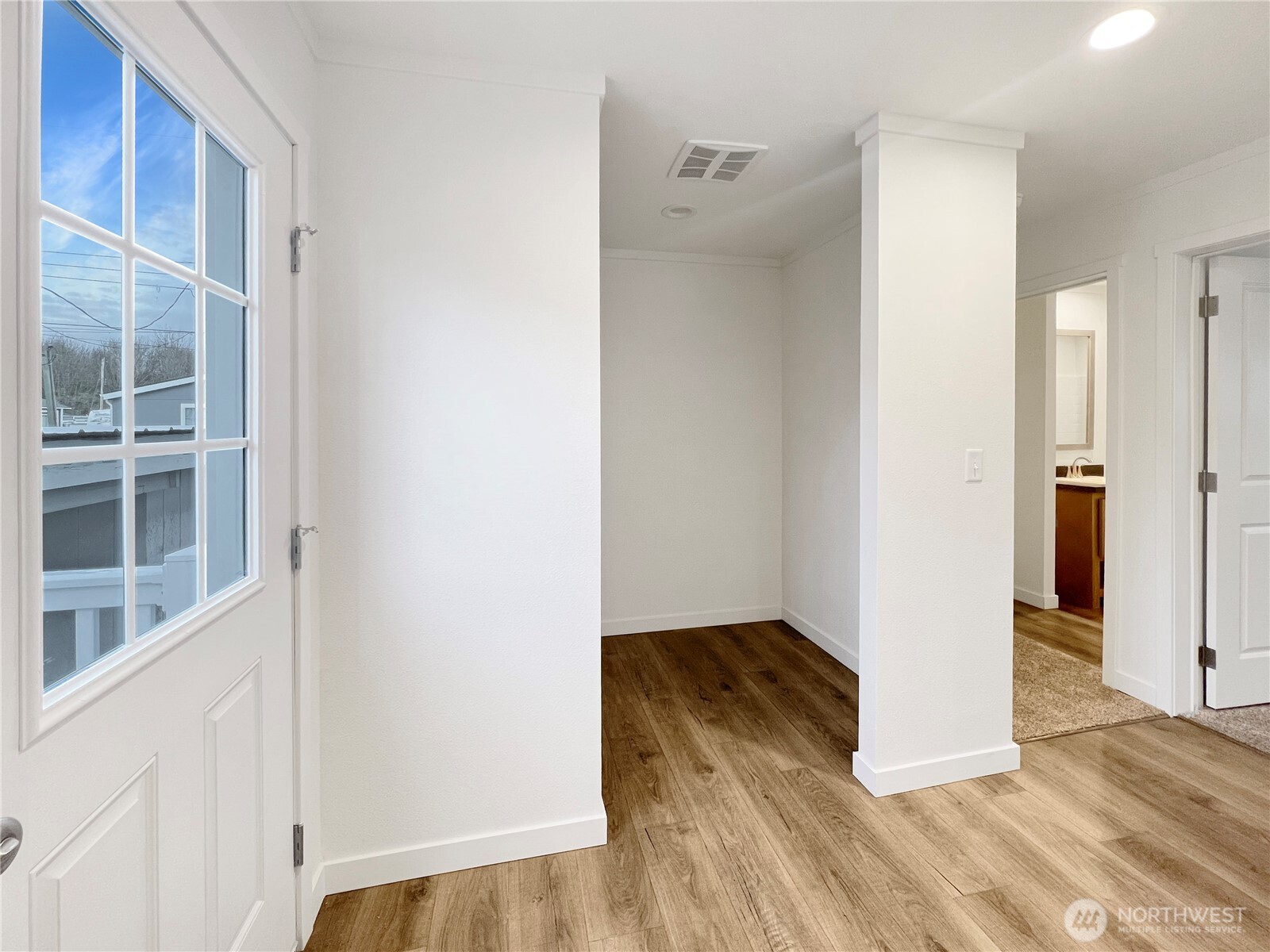 10900 Kuhlman Road Southeast, Unit 84 Olympia, WA 98513 - Photo 12 of 20 a view of an empty room with wooden floor and a window