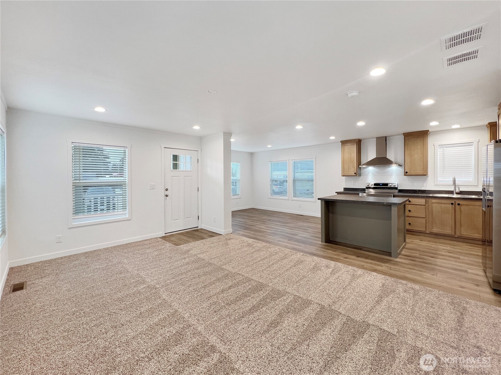 10900 Kuhlman Road Southeast, Unit 84 Olympia, WA 98513 - Photo 3 of 20 a large kitchen with kitchen island granite countertop a large counter top stainless steel appliances and cabinets