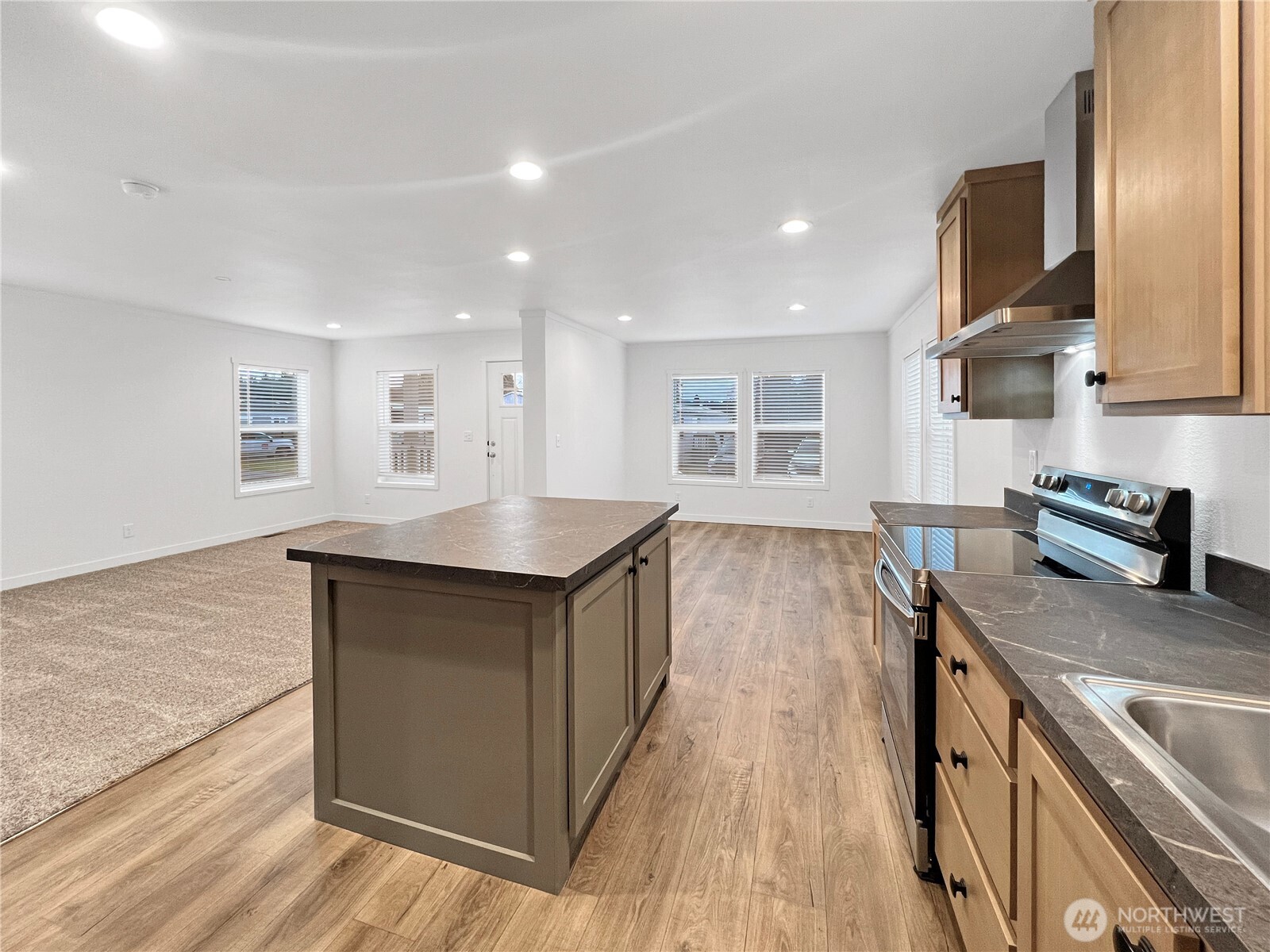 10900 Kuhlman Road Southeast, Unit 84 Olympia, WA 98513 - Photo 9 of 20 a kitchen with granite countertop a stove and a wooden floors