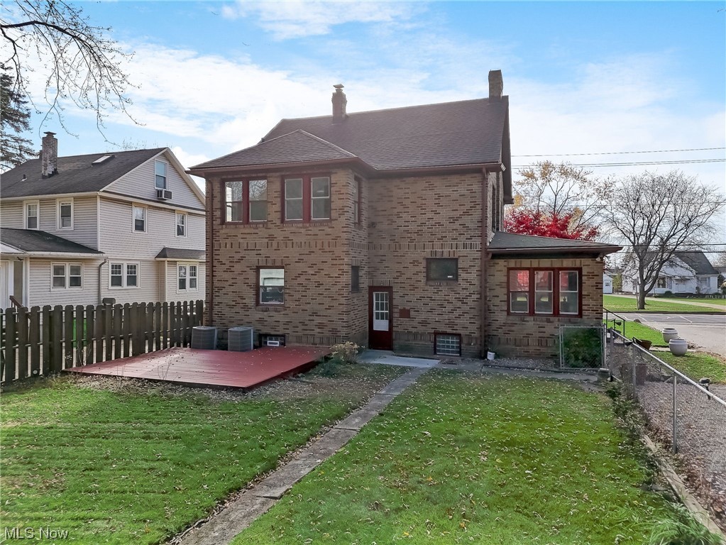 6197 Turney Road Cleveland, OH 44125 - Photo 24 of 35 Back of house featuring a yard and central AC unit