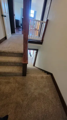 a view of an empty room with staircase