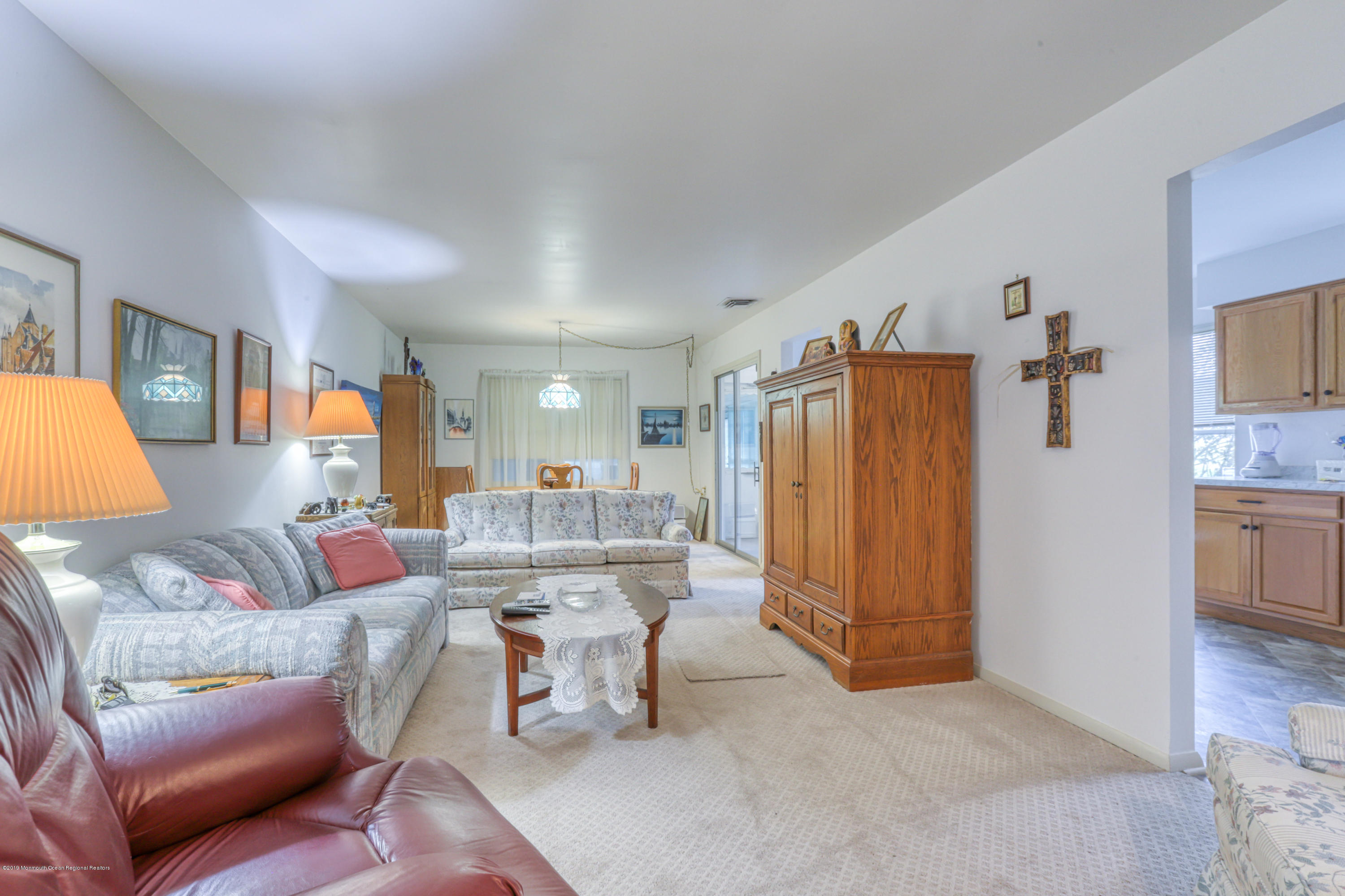 57 Whitman Street Brick, NJ 08724 - Photo 4 of 18 a living room with furniture a refrigerator and a view of kitchen