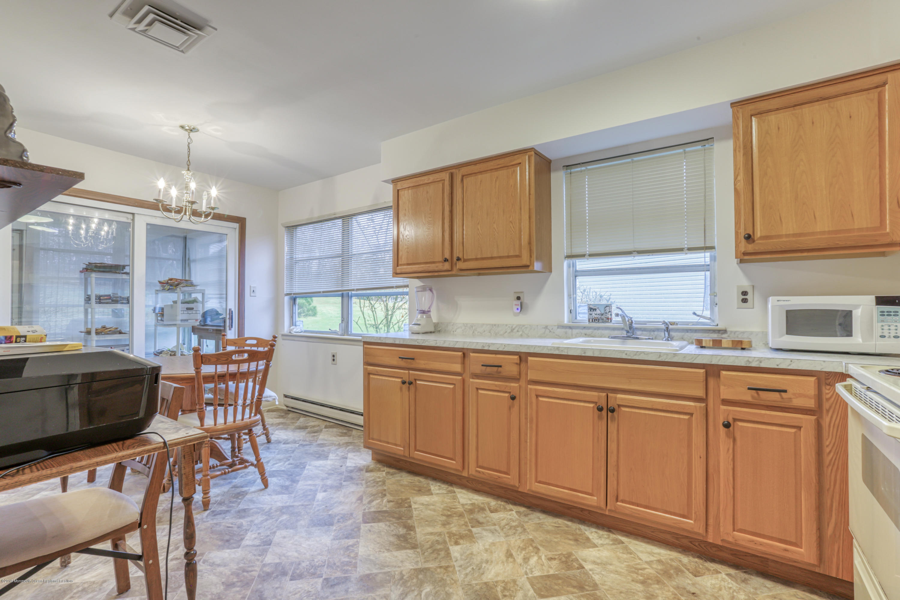 57 Whitman Street Brick, NJ 08724 - Photo 6 of 18 a kitchen with cabinets a sink and chairs