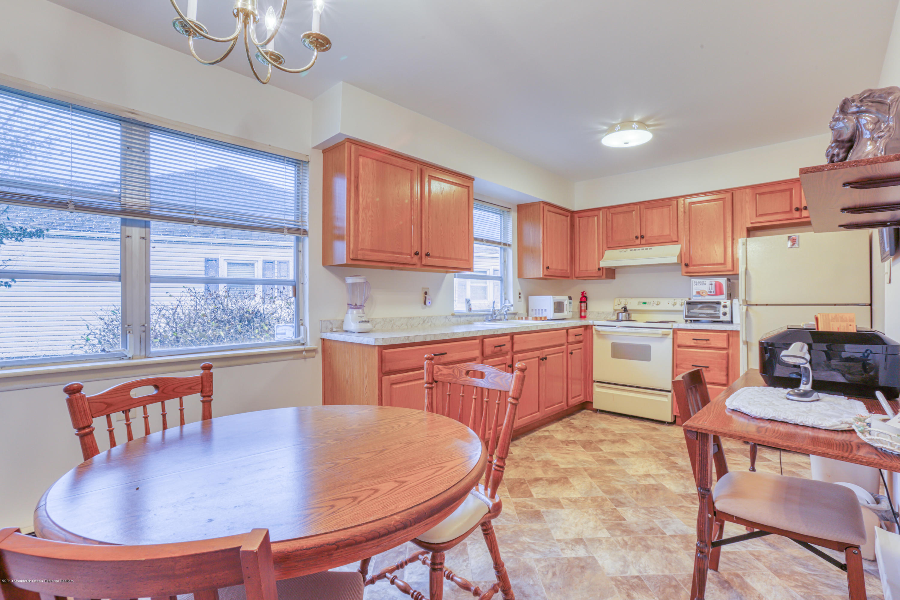 57 Whitman Street Brick, NJ 08724 - Photo 7 of 18 a kitchen with stainless steel appliances granite countertop a sink a stove a kitchen island with chairs and cabinets