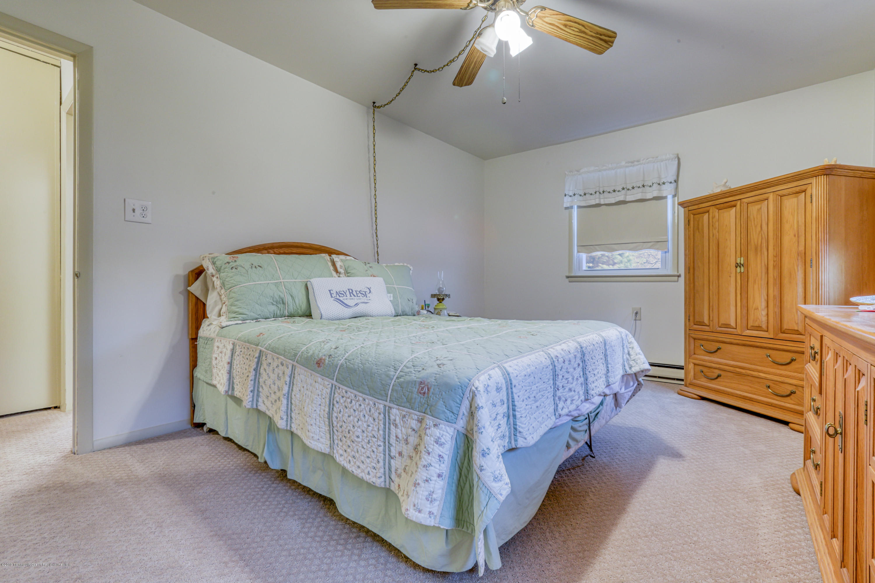 57 Whitman Street Brick, NJ 08724 - Photo 8 of 18 a bedroom with a bed and a chandelier