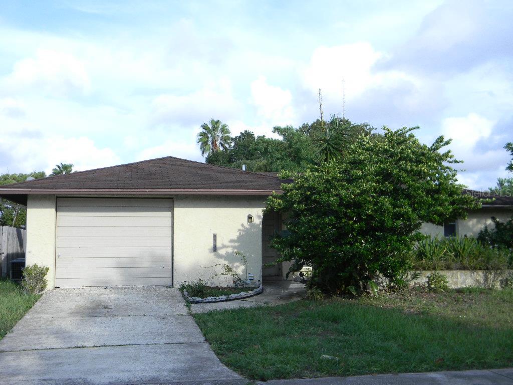 9130 Farmington Lane Port Richey, FL 34668 - Photo 1 of 1 a view of a house with a yard