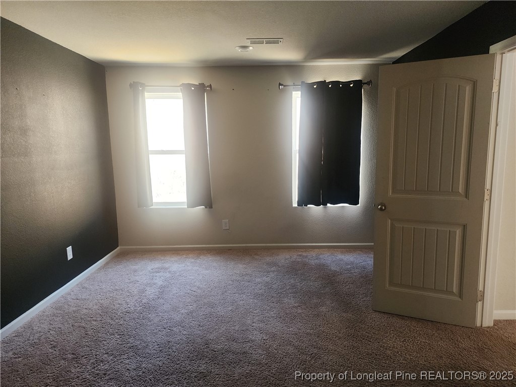 207 Barnsley Road Angier, NC 27501 - Photo 11 of 16 an empty room with windows and closet