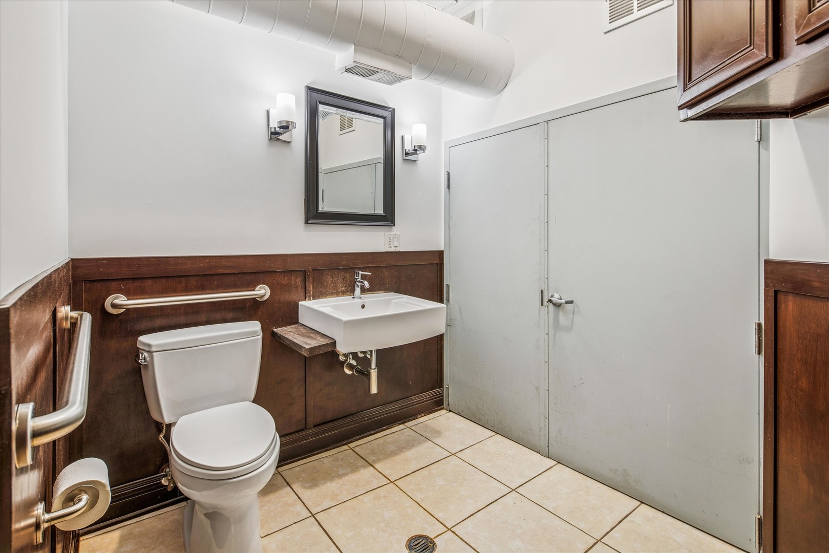 1327 West Washington Boulevard, Unit 105 Chicago, IL 60607 - Photo 15 of 16 a bathroom with a toilet sink and mirror