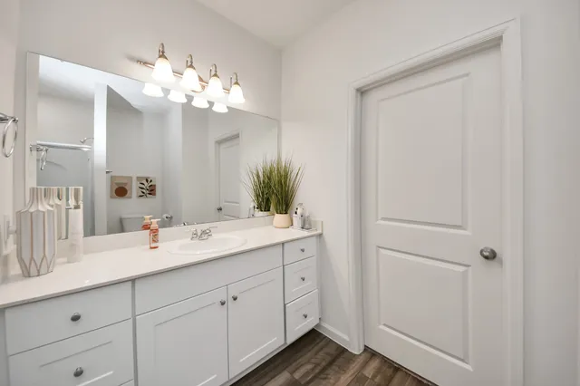 a bathroom with a double vanity sink and mirror