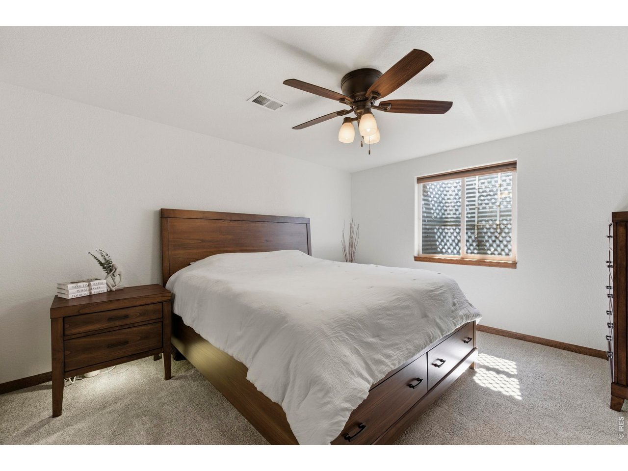 331 South Maple Avenue Eaton, CO 80615 - Photo 31 of 40 a bedroom with a bed and a chandelier