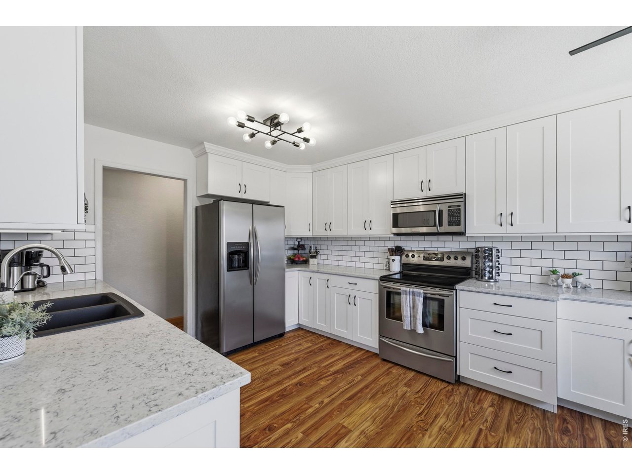 331 South Maple Avenue Eaton, CO 80615 - Photo 10 of 40 a kitchen with a refrigerator sink and cabinets