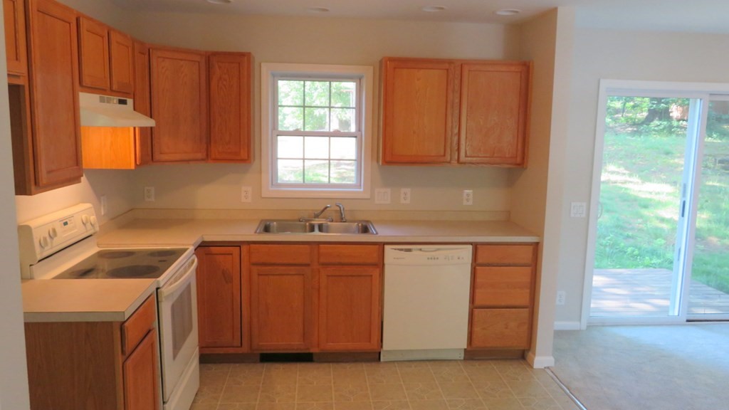 4 Sandy Beach Road Westford, MA 01886 - Photo 12 of 15 a kitchen with granite countertop a sink stove and cabinets