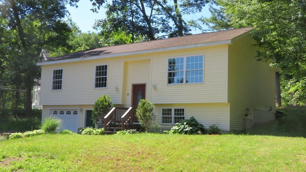 4 Sandy Beach Road Westford, MA 01886 - Photo 2 of 15 a front view of house with yard and green space